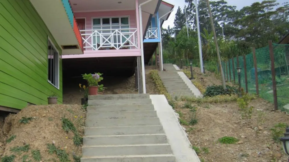 Outdoor steps between colourful accommodation buildings in Kundasang